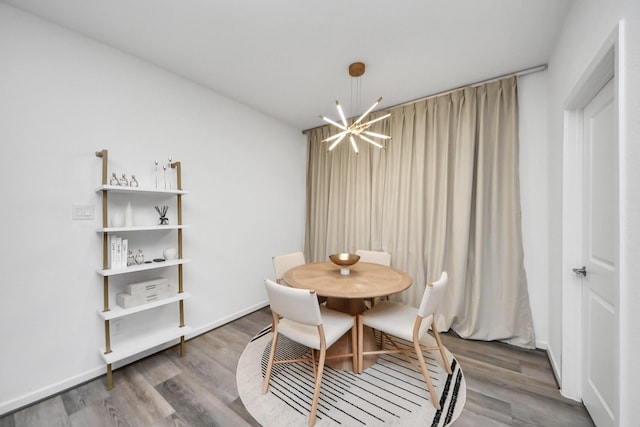 dining room with hardwood / wood-style flooring and a chandelier