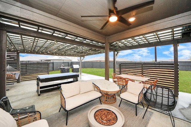 view of patio featuring a pergola, an outdoor living space with a fire pit, and ceiling fan