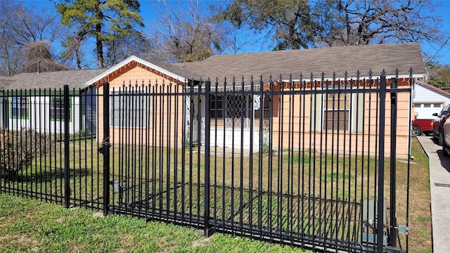 view of gate featuring a lawn