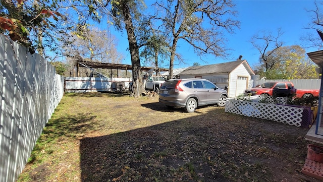 view of yard with a garage and an outdoor structure