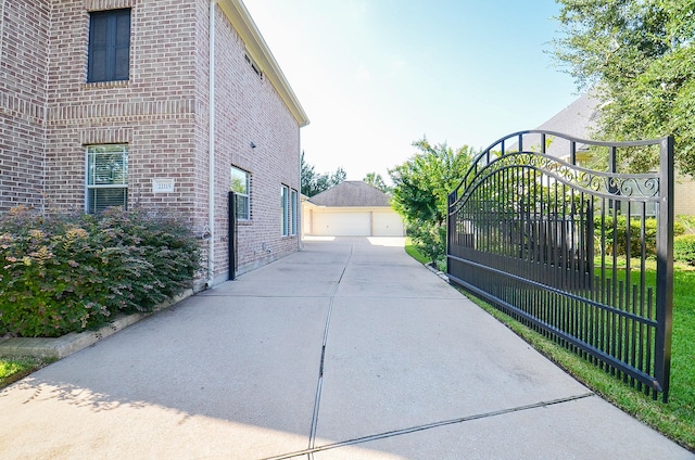 view of gate featuring an outbuilding