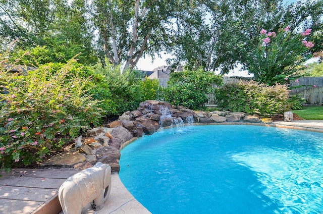 view of pool with pool water feature