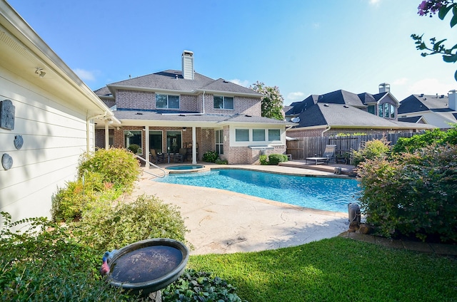 view of pool with an in ground hot tub and a patio