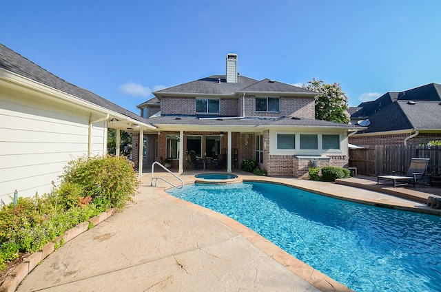 view of swimming pool with an in ground hot tub and a patio area