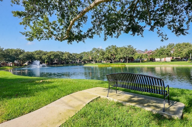 view of community with a water view and a lawn