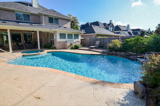 view of pool with an in ground hot tub and a patio area