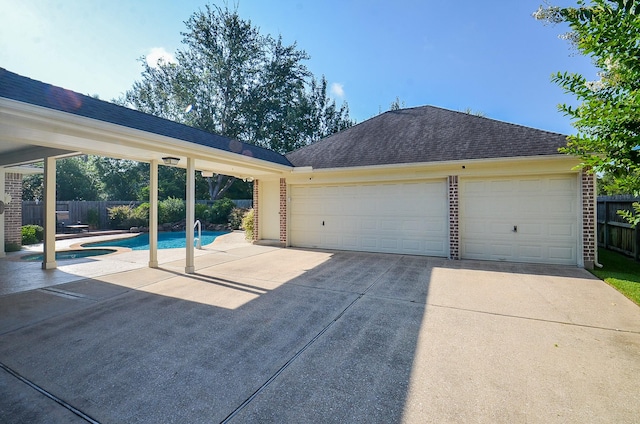 garage featuring a fenced in pool