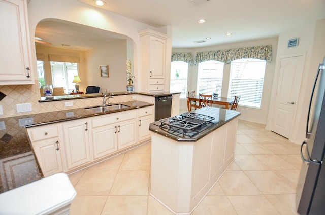 kitchen featuring kitchen peninsula, sink, and white cabinets