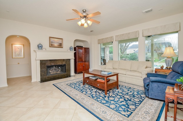 tiled living room with ceiling fan