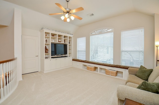 carpeted living room featuring vaulted ceiling and ceiling fan