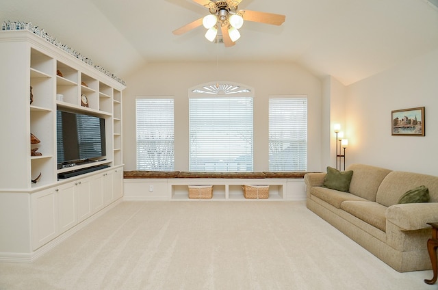 living room with light carpet, vaulted ceiling, and ceiling fan