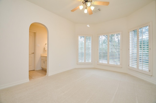 carpeted spare room with ceiling fan