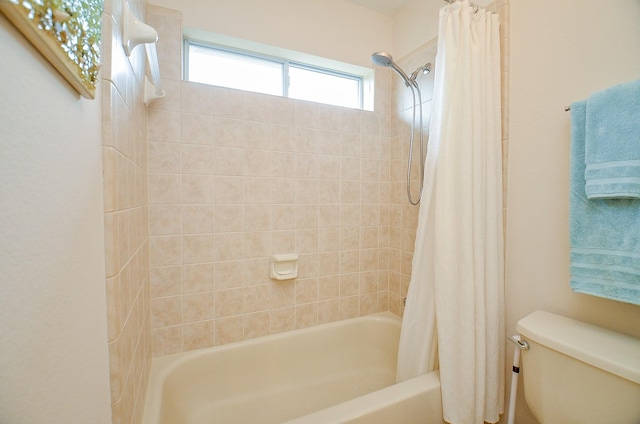 bathroom with shower / bath combination with curtain and toilet