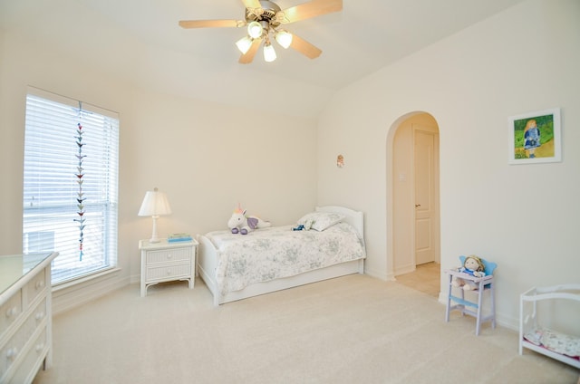 carpeted bedroom featuring lofted ceiling and ceiling fan