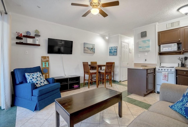 tiled living room featuring crown molding, ceiling fan, and a textured ceiling