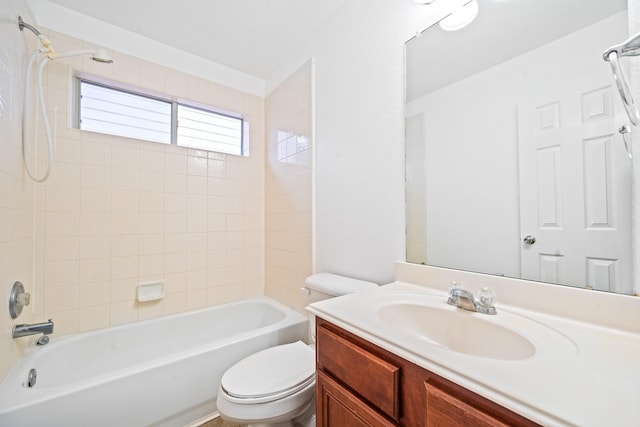 full bathroom with tiled shower / bath, vanity, and toilet