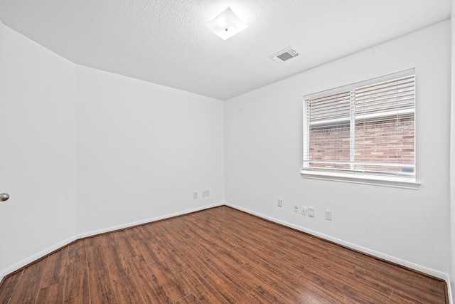 empty room featuring hardwood / wood-style flooring