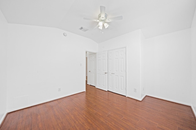 unfurnished bedroom featuring ceiling fan, hardwood / wood-style floors, vaulted ceiling, and a closet