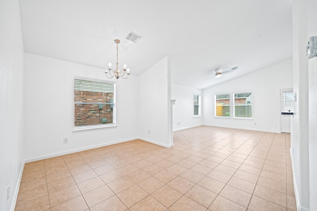 unfurnished room with a notable chandelier, lofted ceiling, and light tile patterned floors