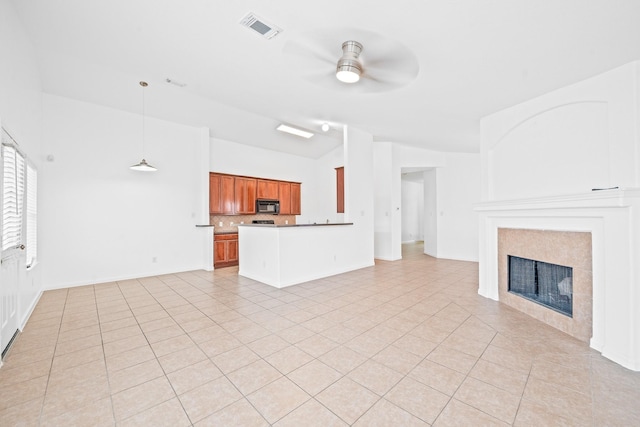 unfurnished living room featuring ceiling fan, lofted ceiling, and light tile patterned floors