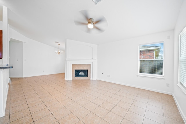 unfurnished living room featuring vaulted ceiling, ceiling fan with notable chandelier, and light tile patterned floors