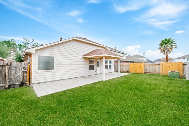 rear view of property with a yard and a patio