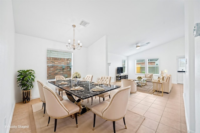 dining area featuring vaulted ceiling, a chandelier, and light tile patterned flooring