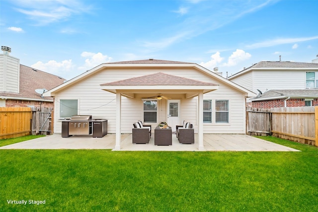 back of property with a patio, a yard, and ceiling fan