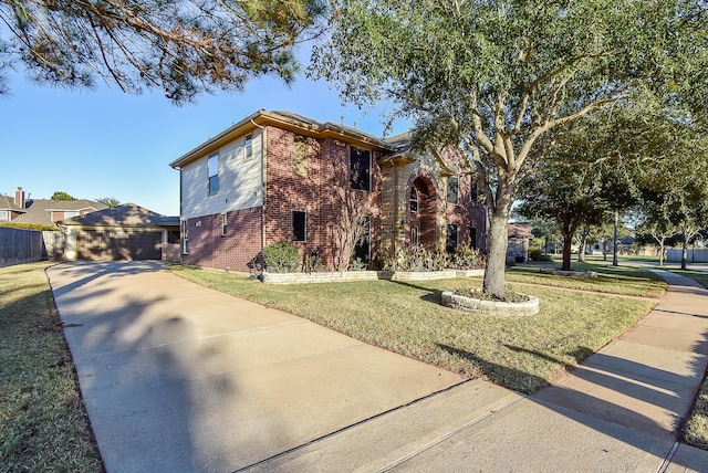 view of front of property featuring a garage and a front yard