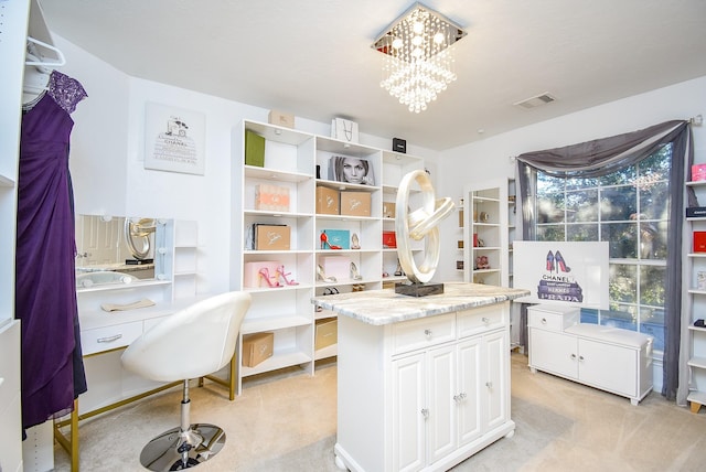 home office with an inviting chandelier and light colored carpet