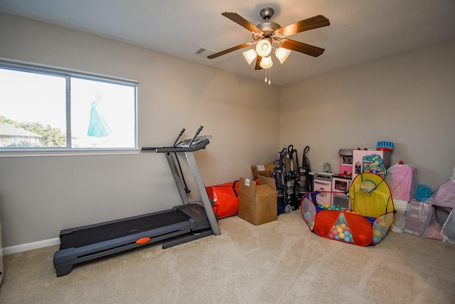 workout room featuring carpet floors and ceiling fan