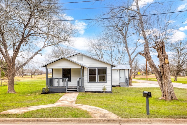 bungalow with a porch and a front lawn