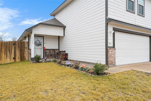 view of side of home with a garage and a yard