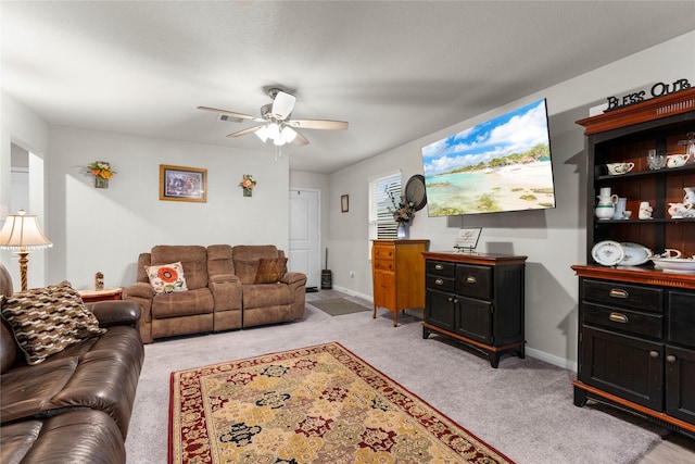 carpeted living room with ceiling fan