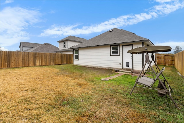 rear view of house with a lawn