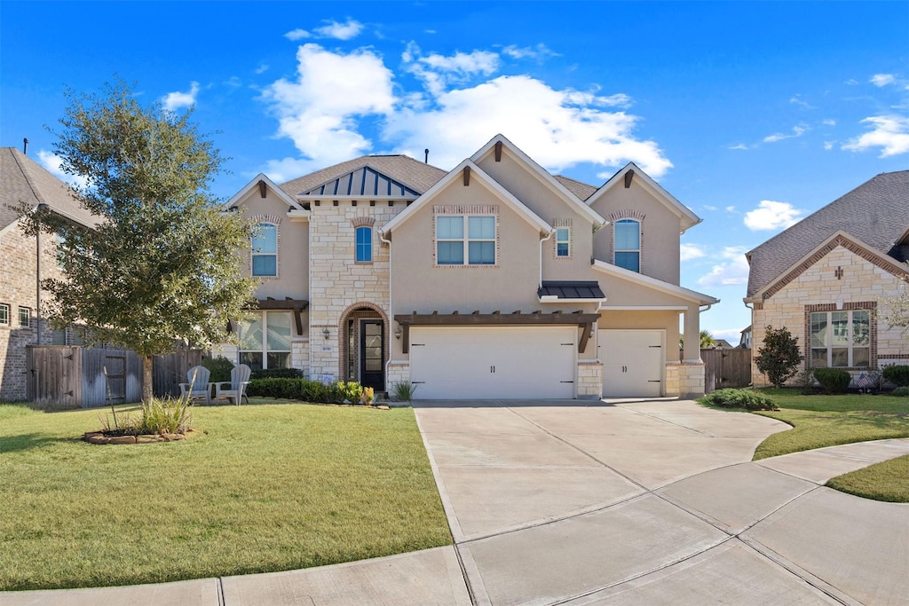 view of front of house featuring a garage and a front lawn