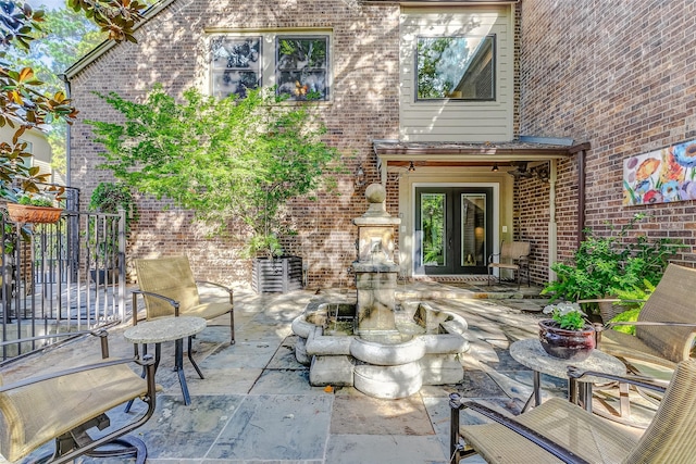 entrance to property featuring french doors and a patio area