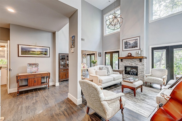 living room featuring a fireplace, a wealth of natural light, and dark hardwood / wood-style floors