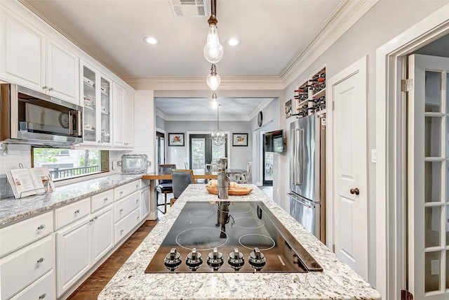 kitchen with crown molding, white cabinetry, hanging light fixtures, stainless steel appliances, and dark hardwood / wood-style flooring