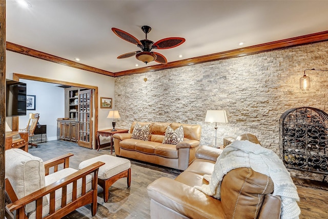 living room featuring hardwood / wood-style flooring, crown molding, and ceiling fan