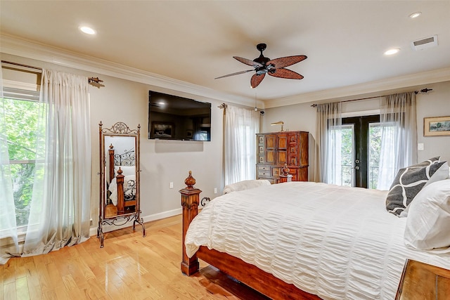 bedroom with french doors, ornamental molding, wood-type flooring, and access to outside