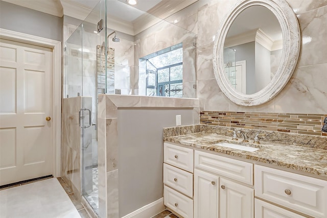 bathroom featuring a shower with door, ornamental molding, tasteful backsplash, and vanity