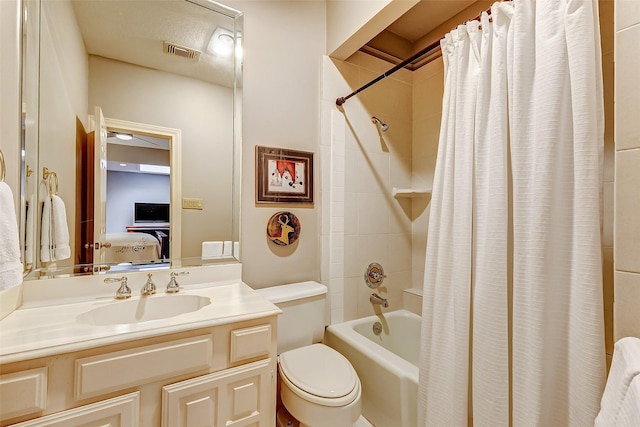 full bathroom featuring vanity, shower / tub combo, and toilet