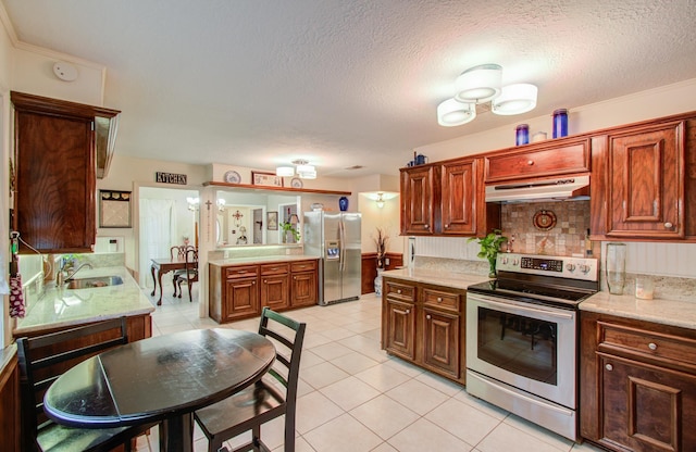 kitchen featuring sink, light tile patterned floors, stainless steel appliances, light stone countertops, and decorative backsplash