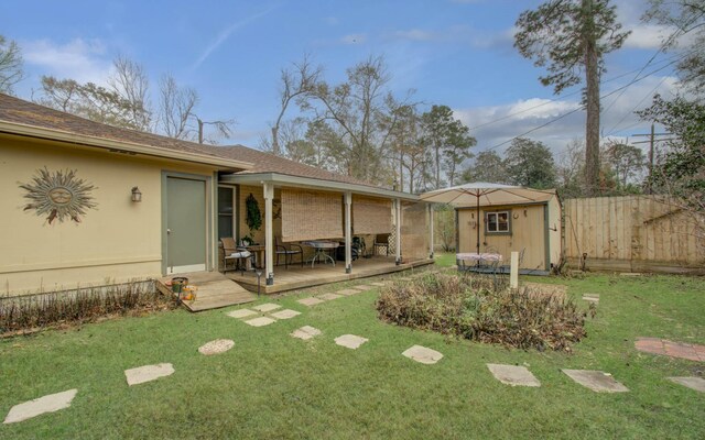 view of yard with a wooden deck and a storage shed