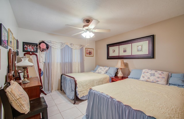 tiled bedroom featuring ceiling fan and a textured ceiling