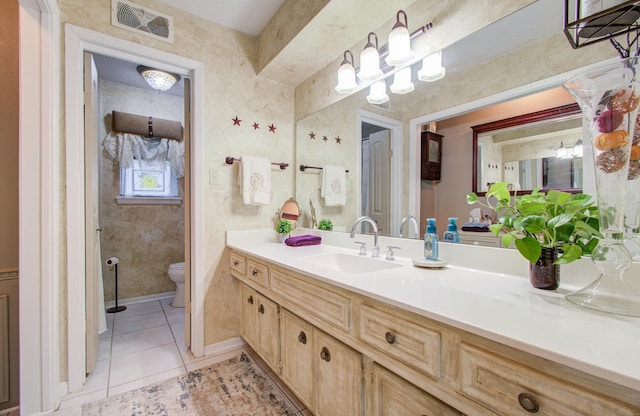 bathroom with vanity, tile patterned floors, and toilet