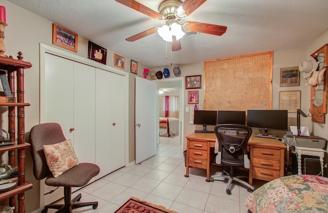 office area featuring light tile patterned floors, a textured ceiling, and ceiling fan