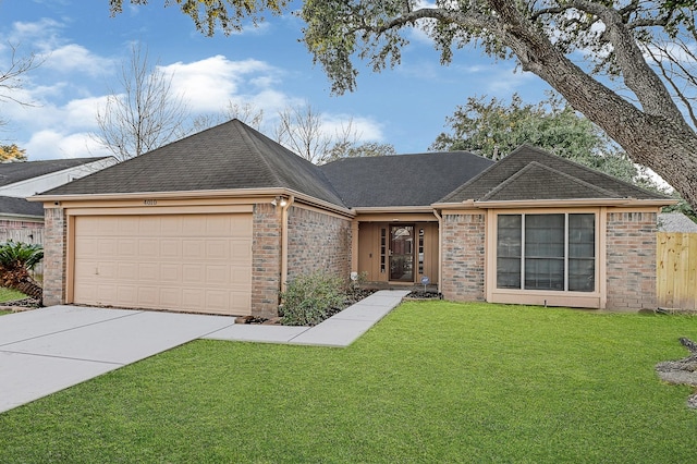 single story home with a garage and a front yard