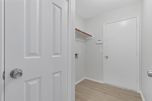 laundry room with light hardwood / wood-style floors